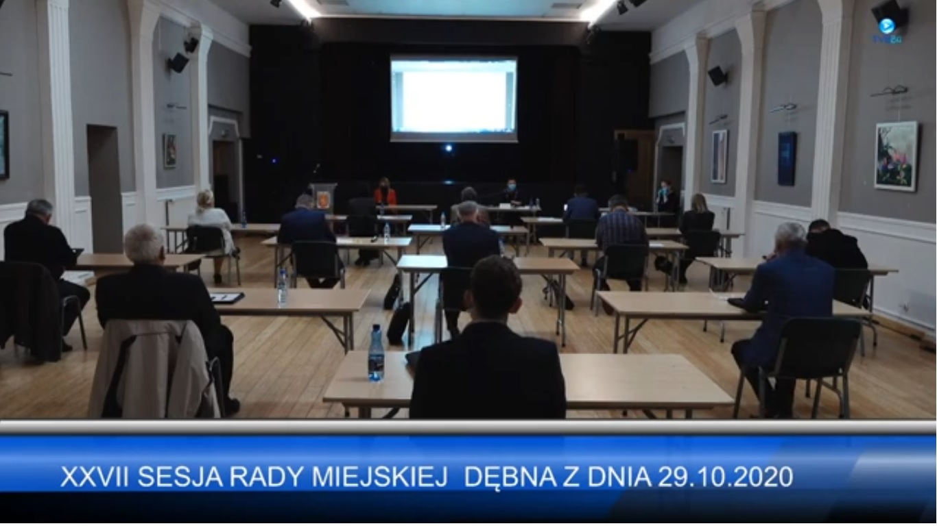 Powiększ zdjęcie. Radni siedzą (widok od tyłu) każdy przy swoim stole