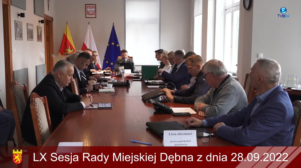 Powiększ zdjęcie. Radni siedzą w sali posiedzeń. Zrzut z filmu