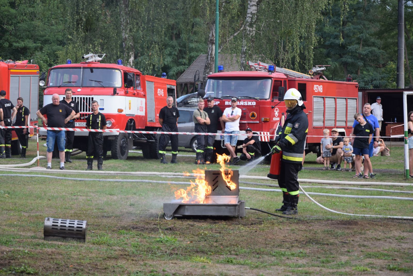 Pokazy pożarnicze. Strażak gasi pożar