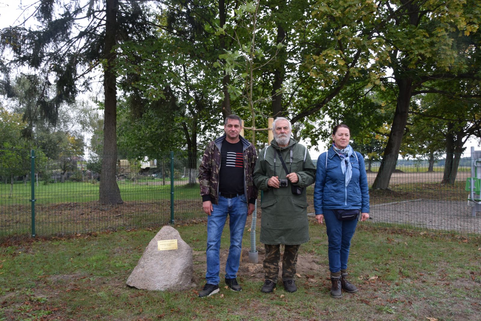 Sołtys Andrzej Łaszewski, Marek Schiller, Maria Woś przed pamiątkowym dębem