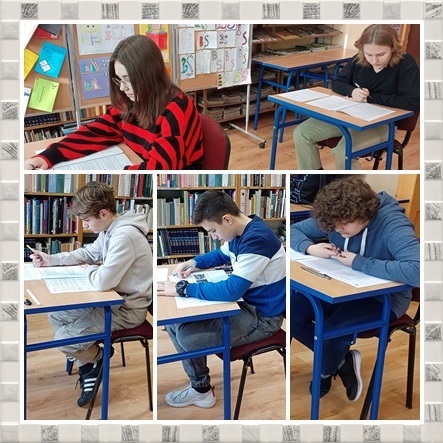 Powiększ zdjęcie. Uczniowie siedzą w ławkach. Wypełniają testy