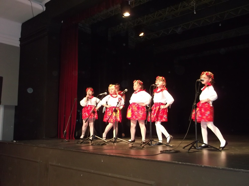 Pięć dziewczynek śpiewa na scenie