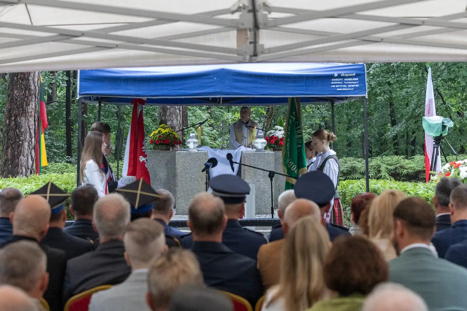 Ksiądz przy polowym ołtarzu w lesie