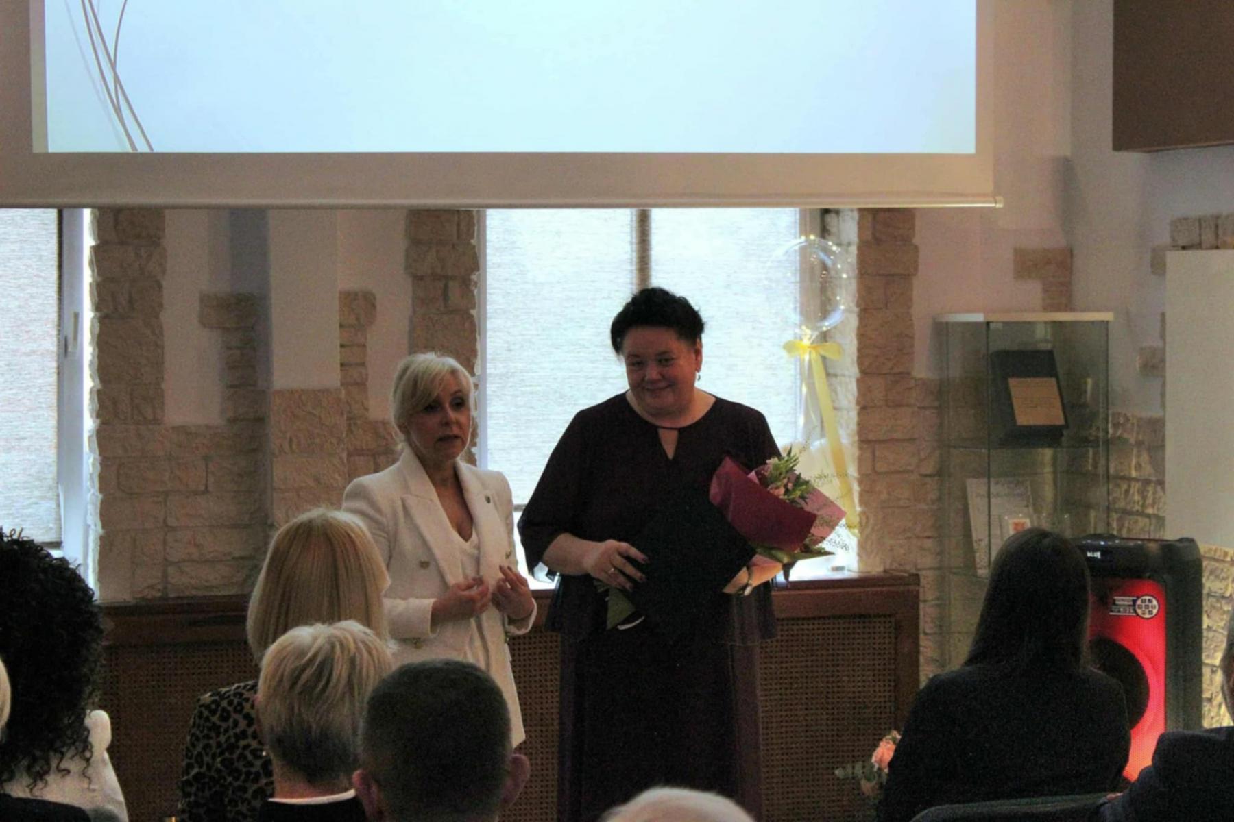 Pani wicestarosta i pani Dyrektor stoją, w sali zgromadzeni goście 