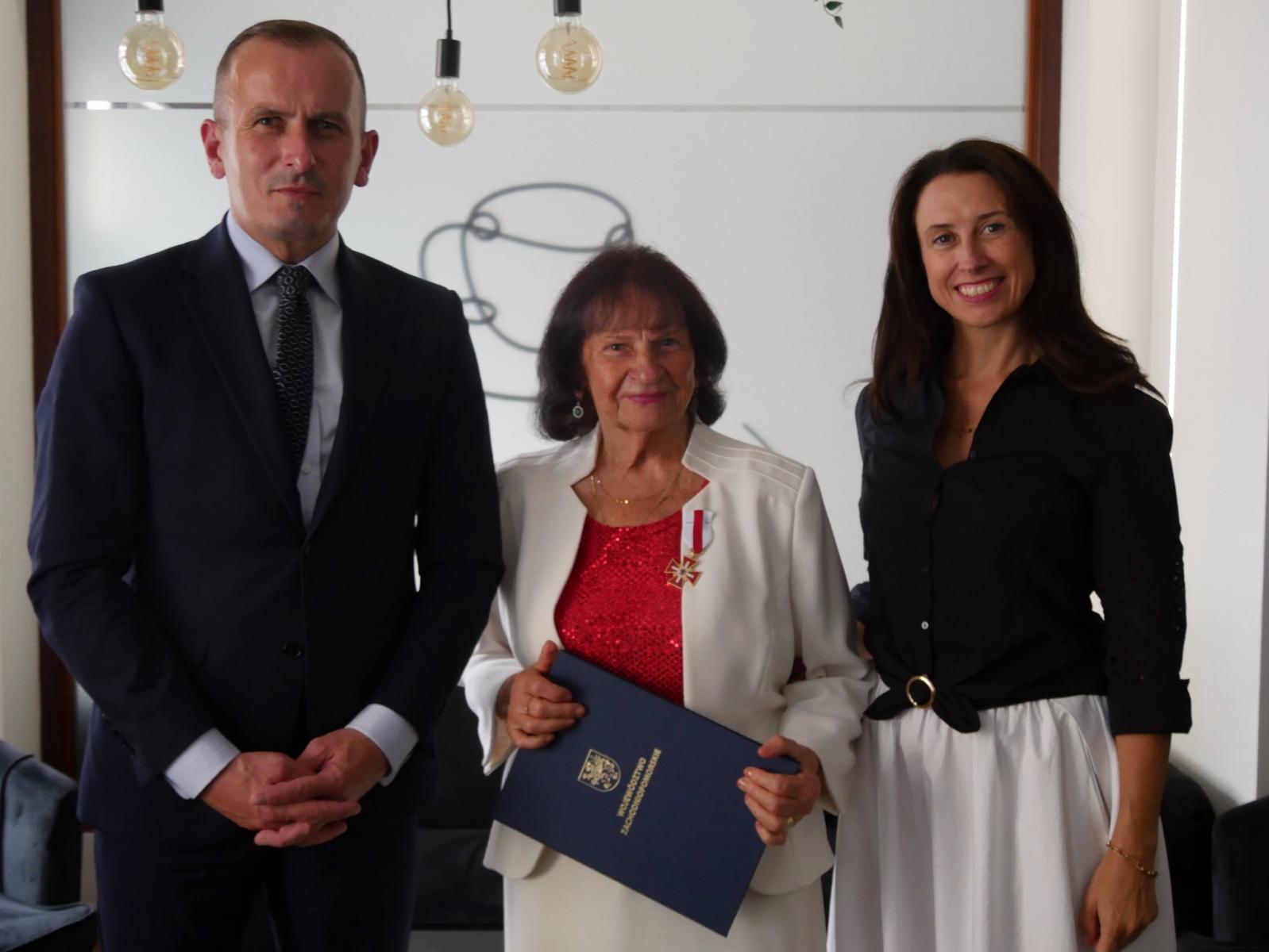 Od lewej w sali stoją M. Łapeciński, Aniela Głodna, dyrektor DOK-u J. Rau
