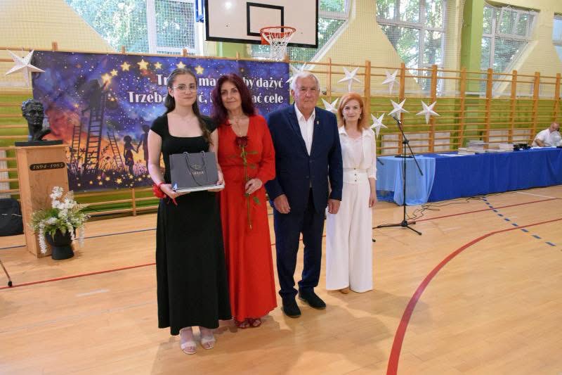 Na hali od lewej stoją: uczennica, nauczycielka, radny Rady Miejskiej Dębna, pani dyrektor